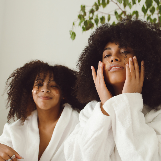 Two women with skin care masks doing at home skin care routine