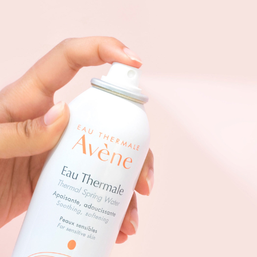 Hand model with a bottle of Avene Eau Thermale