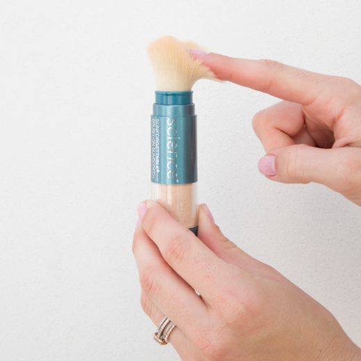 Image of hand model holding Colorescience Sunforgettable Brush On Shield SPF 50