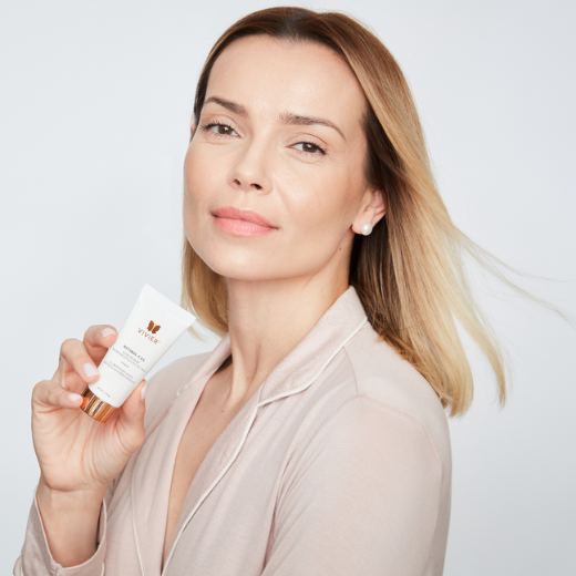 Model holding a bottle of Vivier Retionl 1.0% 