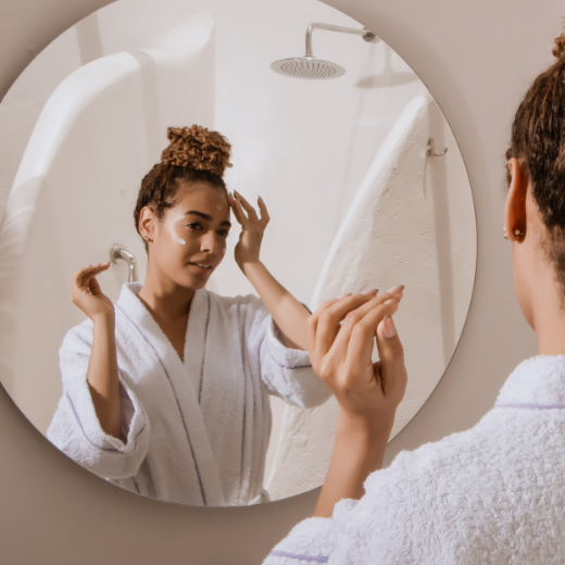 Model applying cleanser to their face.