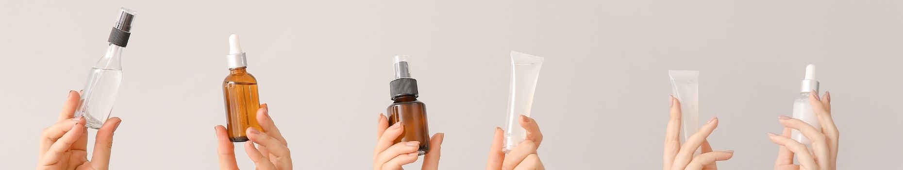 Skincare Product Bottles in Hands