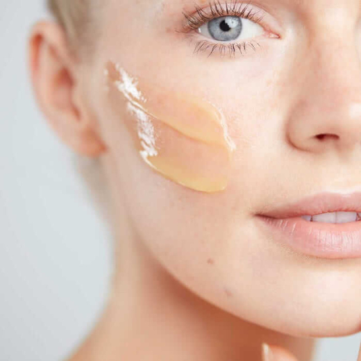 Woman with Elemis Pro Collagen Cleansing Balm on her cheek