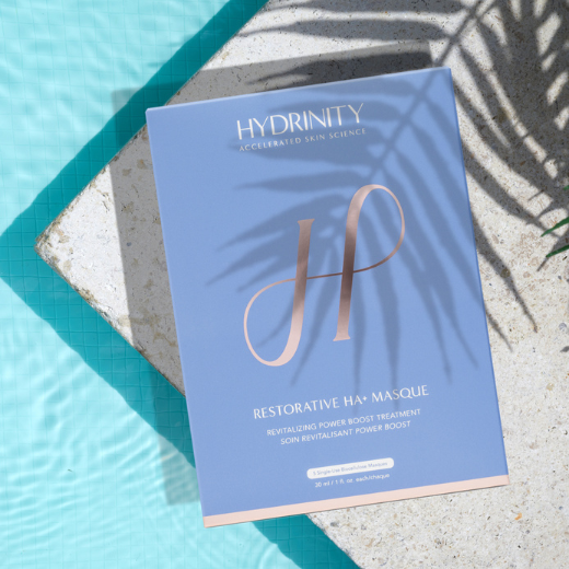 Hydrinity Restorative HA+ Masque next to pool with palm shadow