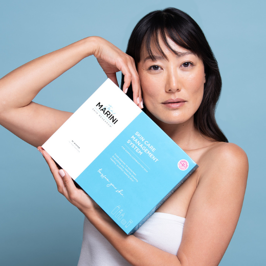 Jan Marini Skin Care Management System box held by model