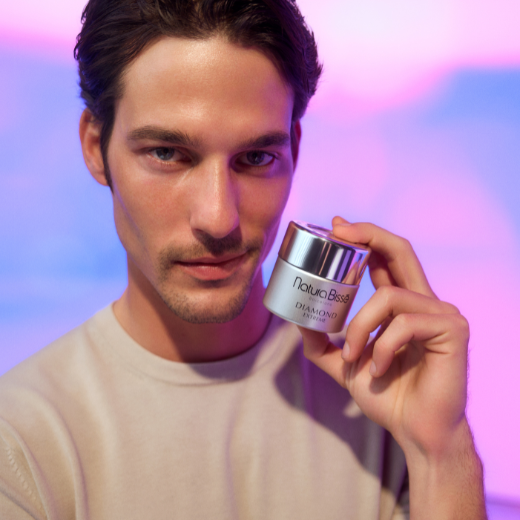 Image of model holding Natura Bissé Diamond Extreme Cream