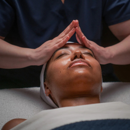 Esthetician performing a Naturopathica spa service on a woman