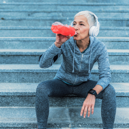 Woman Drinking Flavored Water After Working Out