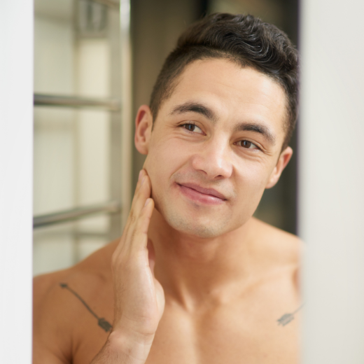 Man touching his face after daily skincare routine