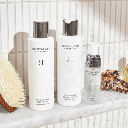 Woman applying mascara to eyelash extensions