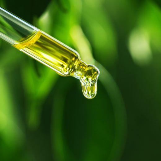 Image of skin care serum on a dropper depicting green tea as the main ingredient 